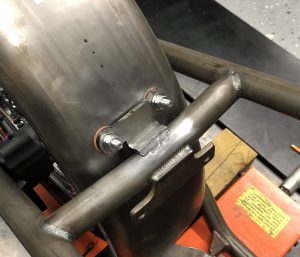 Rear fender bracket welded to frame.