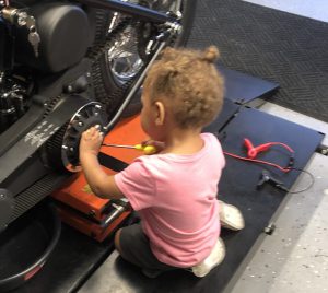 Granddaughter working on the motorcycle.