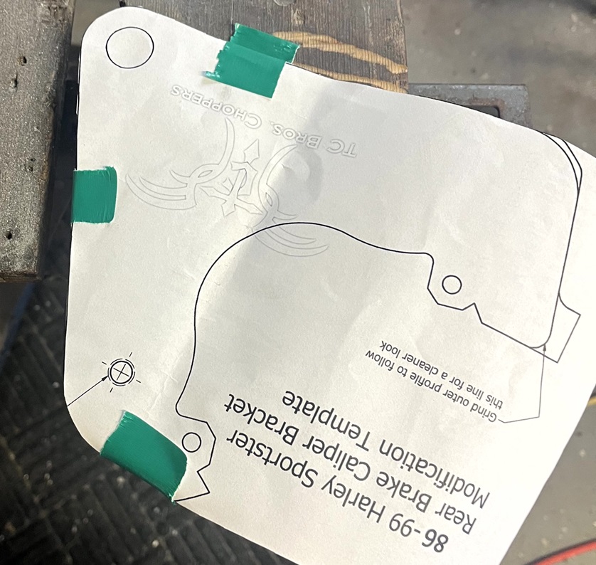 Using template to mark hole for brake bracket support.
